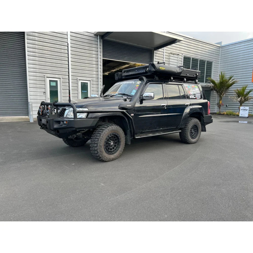 Black off-road vehicle with roof tent fitted with Rockarmor Brushbar for Nissan Patrol GU1
