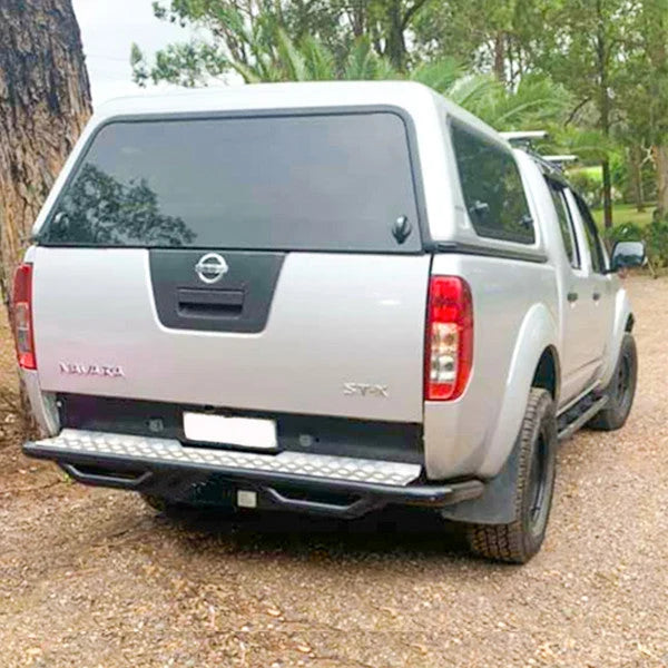 Silver nissan navara d40 rear showing rockarmor premium steel rear step tow bar with 2500kg towing capacity