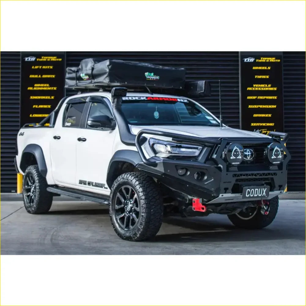 White toyota hilux 2022 widebody with black gt hoop bullbar roof rack and rock sliders off-road accessories