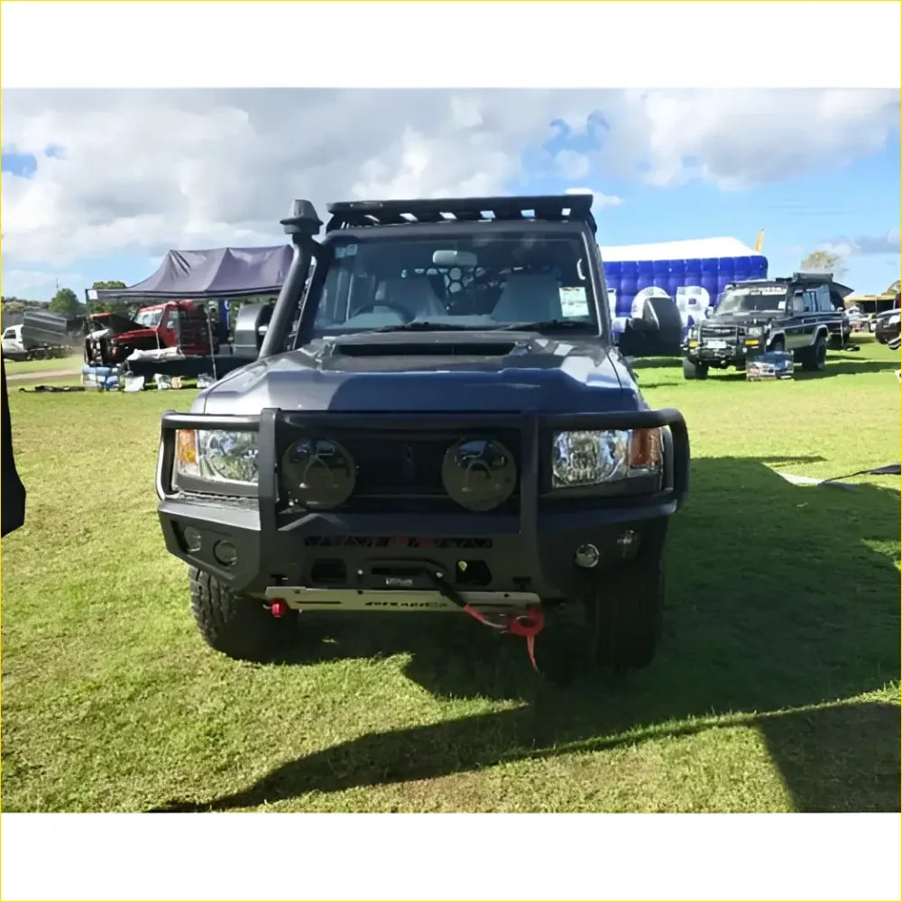 Black armored off-road toyota landcruiser 78 troopy with rugged gt hoop bullbar rock sliders and roof rack