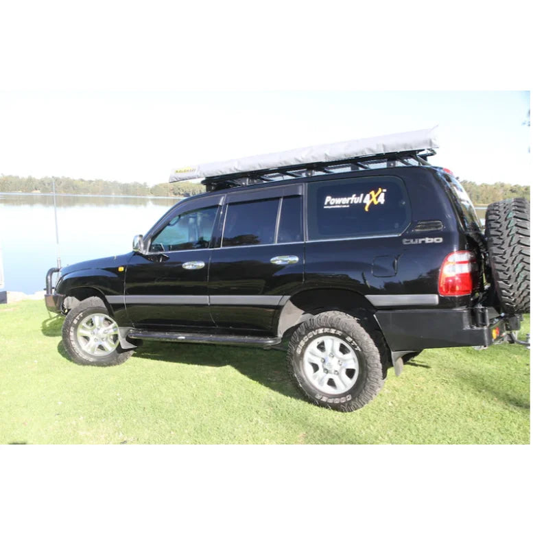 Black four-wheel-drive vehicle with Rockarmor Steel Dual Wheel Carrier for Toyota Landcruiser FJ105