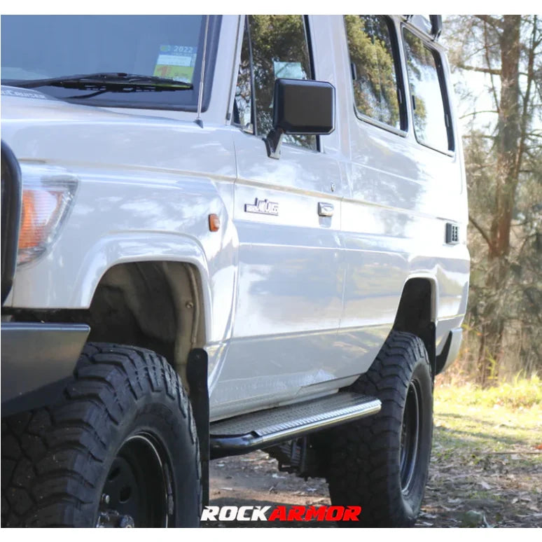 White off-road vehicle with steel checker plate Rockslider side steps on Toyota Landcruiser