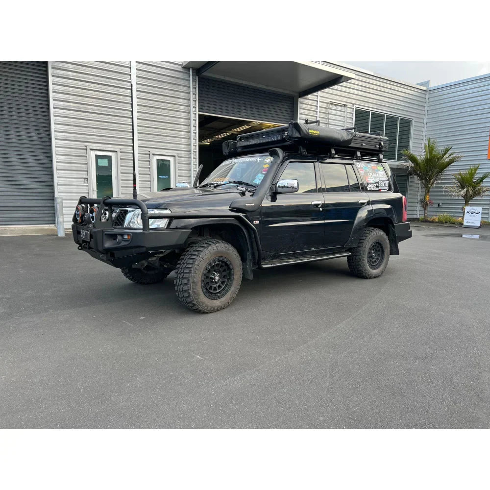 Black nissan patrol gu1 with rockarmor brushbar and roof tent showcasing the premium bullbar front protection