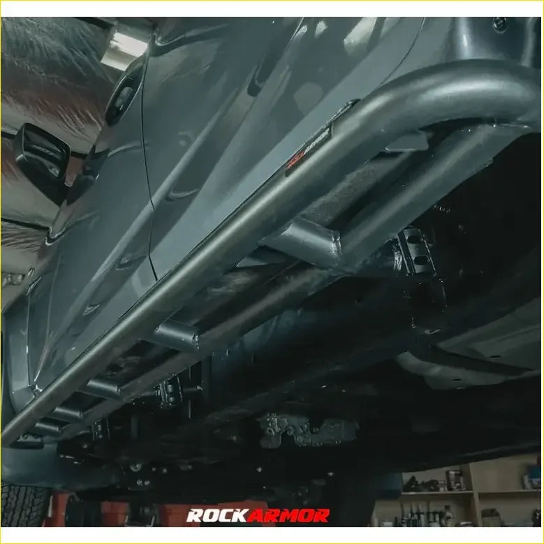Black metal rock guard with rugged tubular design and visible welds on rockarmor rock pack for isuzu dmax 2017-2020