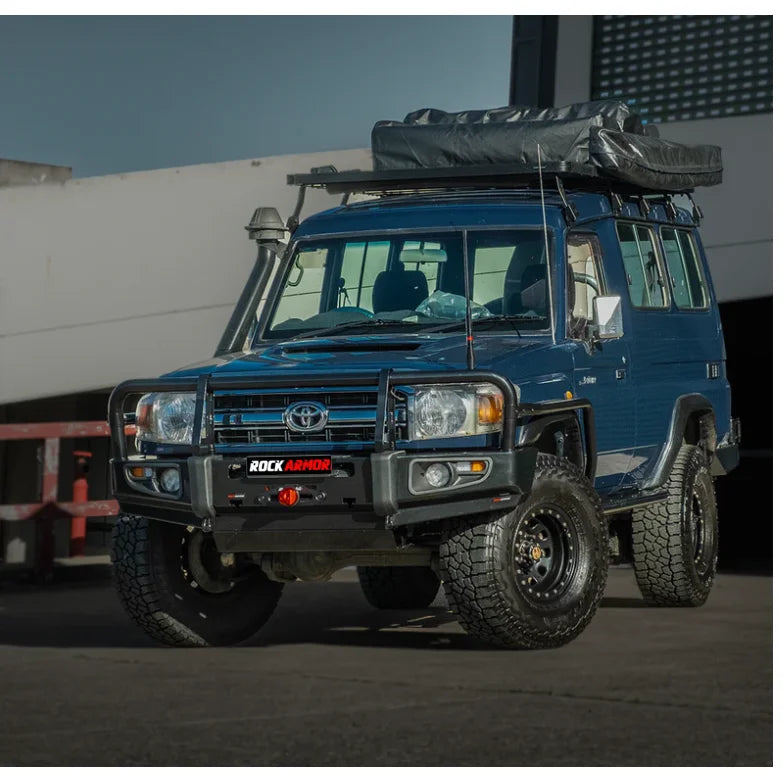 Blue toyota landcruiser 76 series with rockarmor steel rockslider checker plate step side steps and roof tent